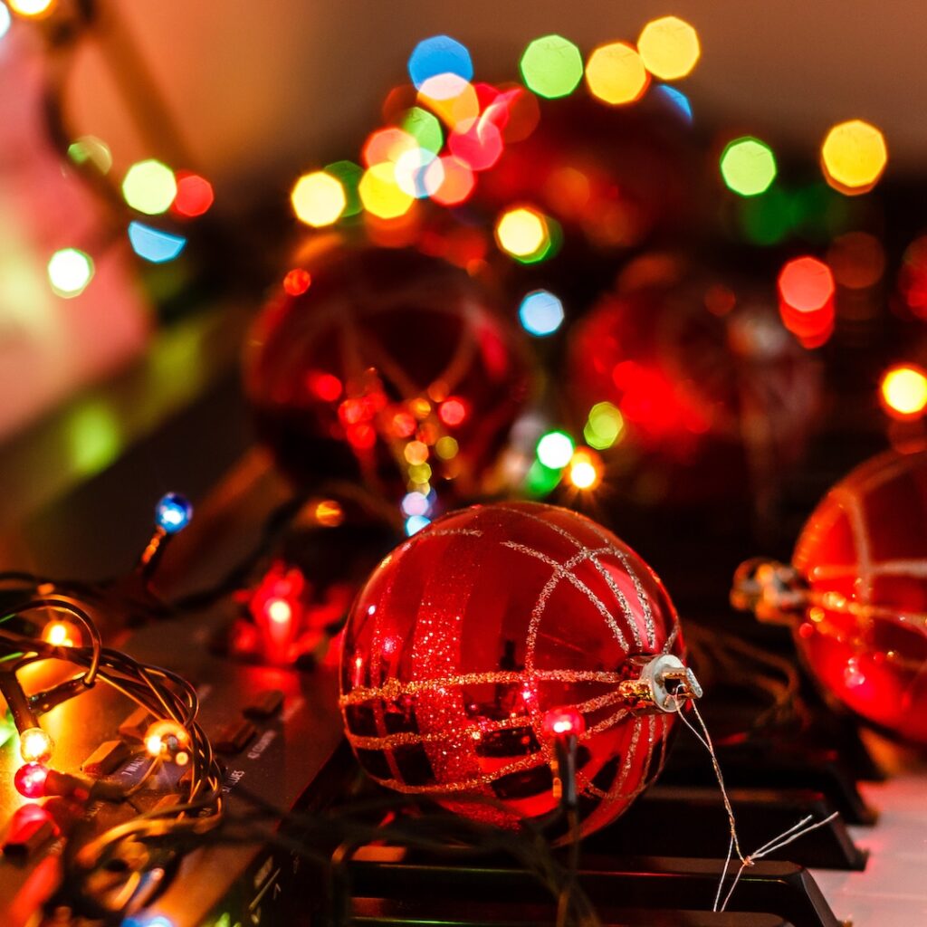 Piano keyboard with Christmas decoration, closeup